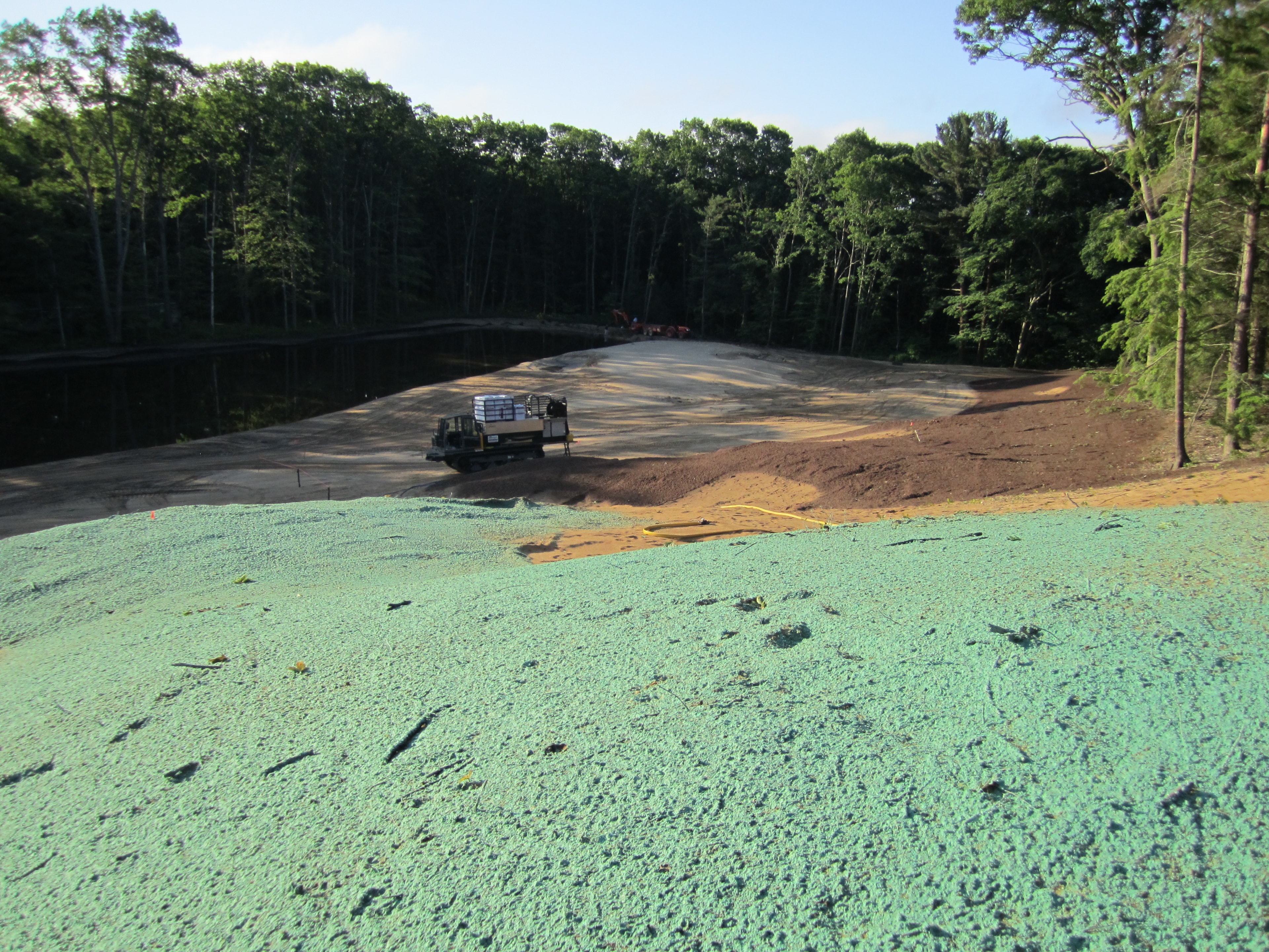 Green hydromulch applied along a fairway beside a pond at American Dunes