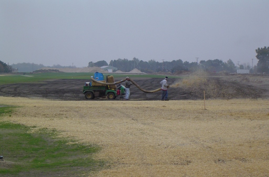 Straw mulching operation at Macatawa Legends golf course