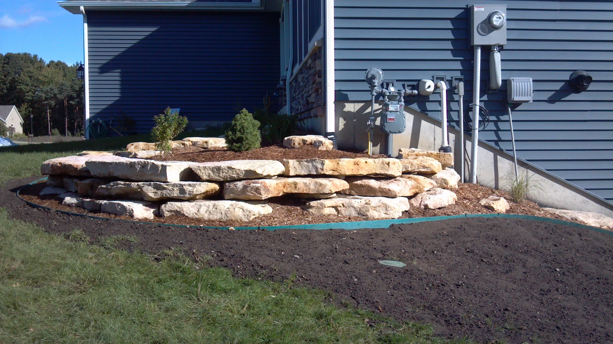 Stone retaining wall with planting beds